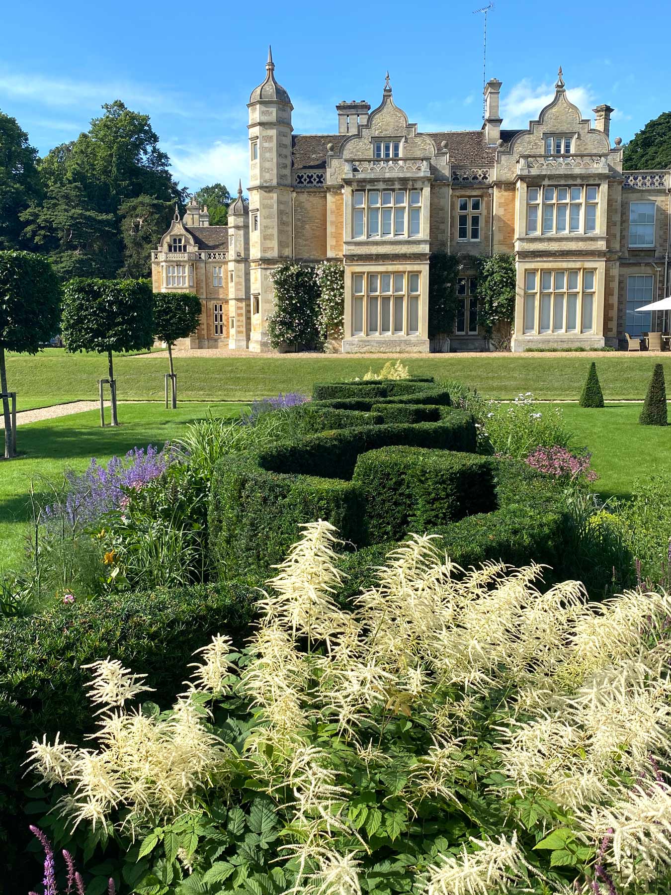 Plaited yew hedge along centre of mixed border in new formal garden at Exton Hall designed by Peter Eustance