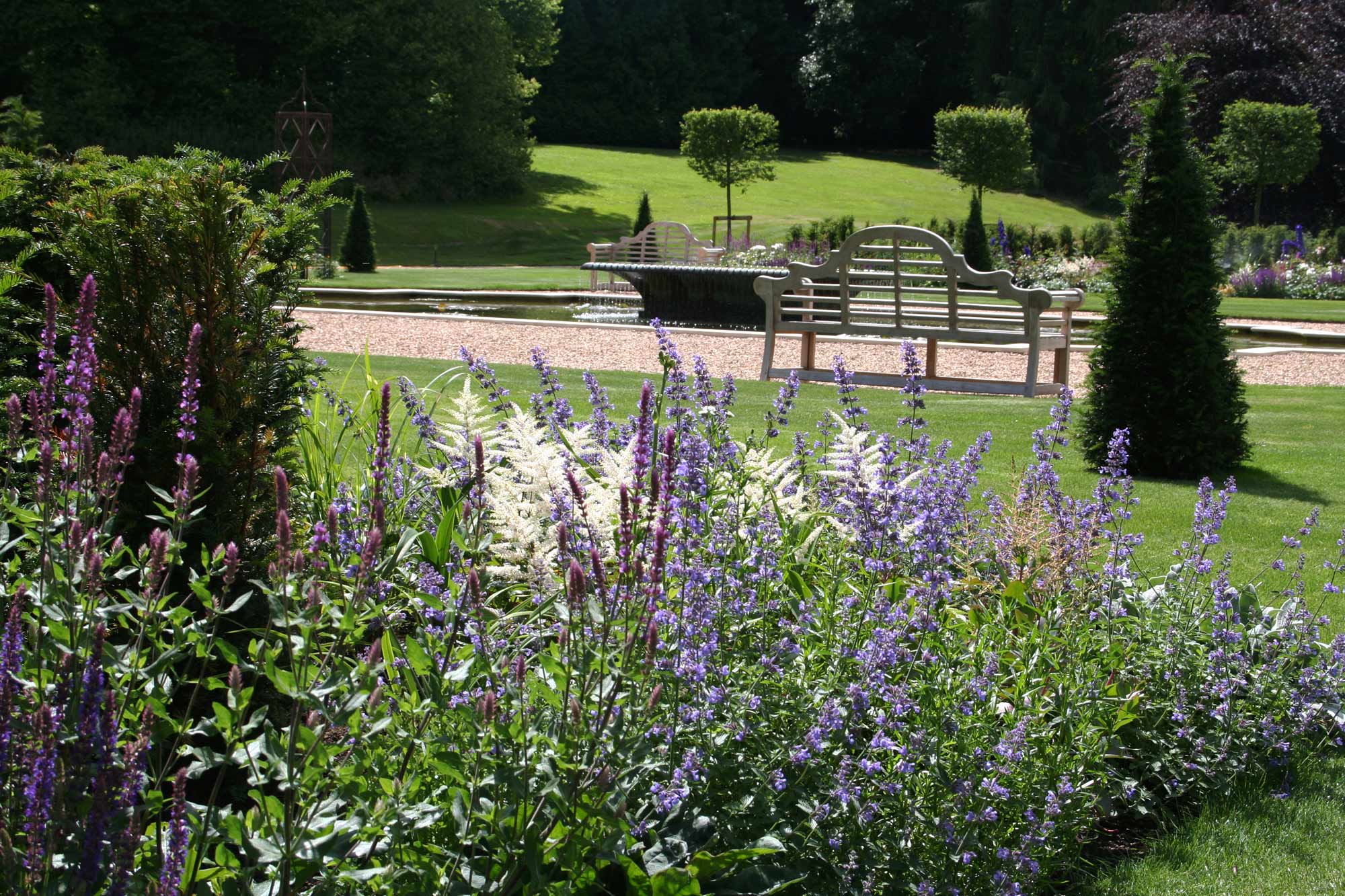 View across planted borders to Lulworth water feature in new formal garden at Exton Hall designed by Peter Eustance