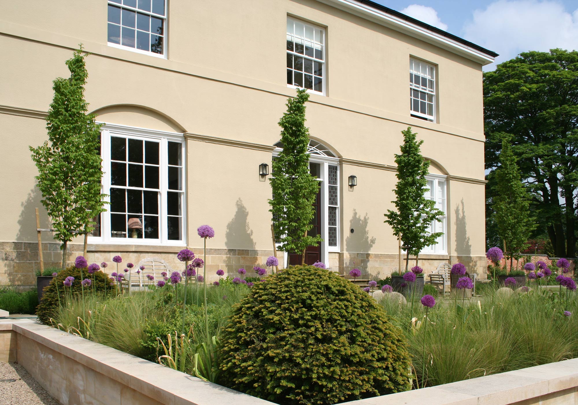 Terraced levels and planted borders complete improvements to the newly restored country home landscape designed by Peter Eustance