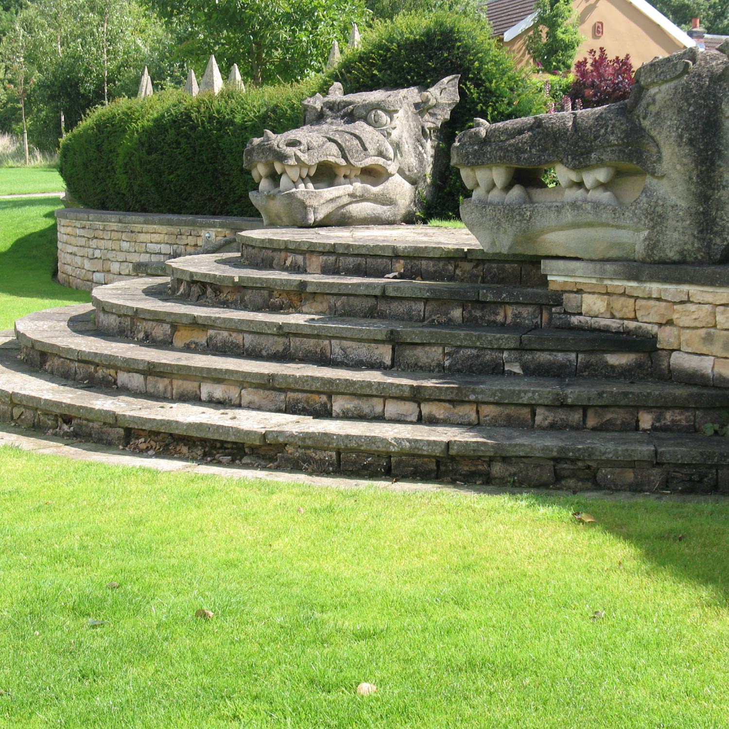 Ladywood The pair of bath stone dragons heads guard the steps in the garden of a country lodge in Leicestershire designed by Peter Eustance