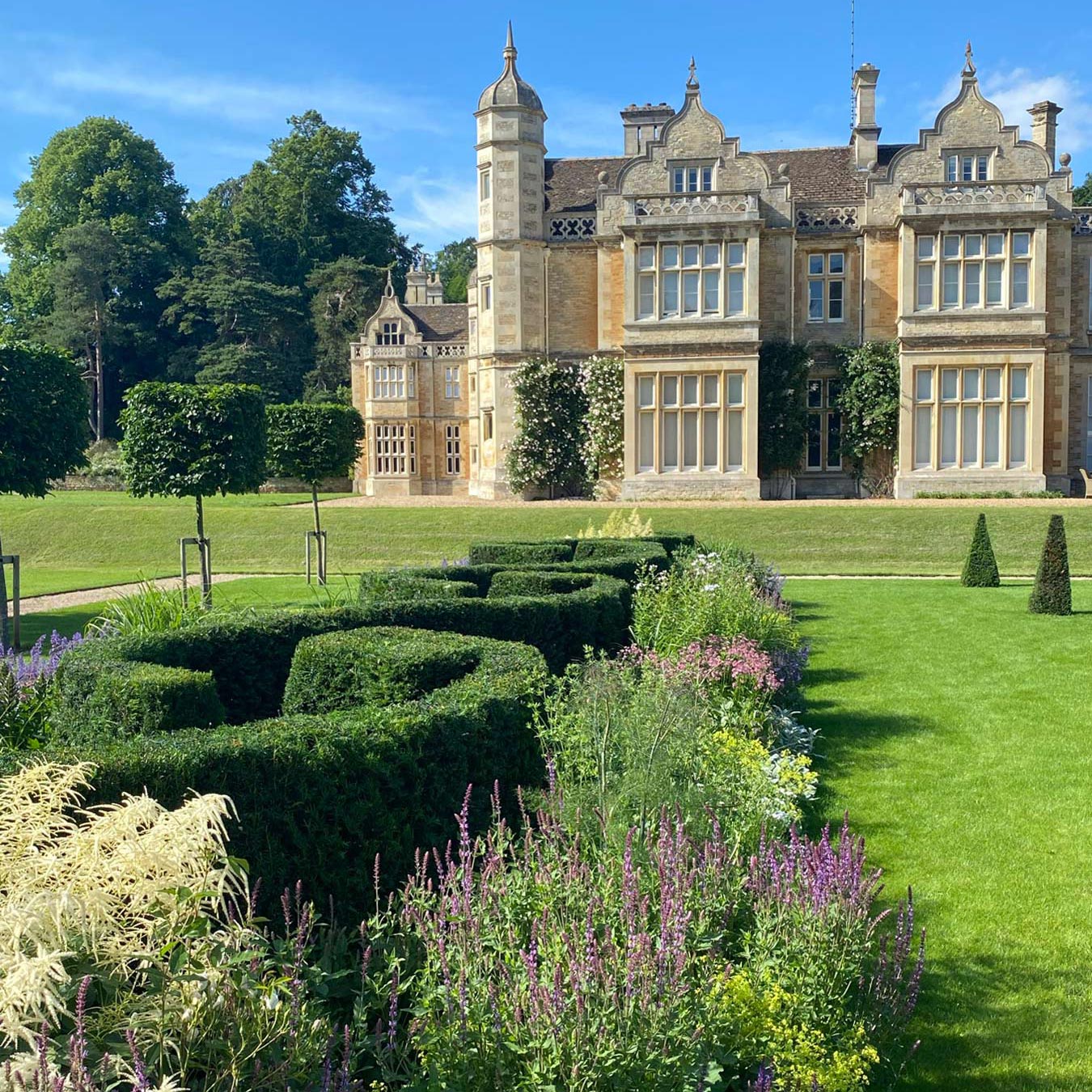 Plaited yew hedge and planted borders in new formal garden at Exton Hall designed by Peter Eustance