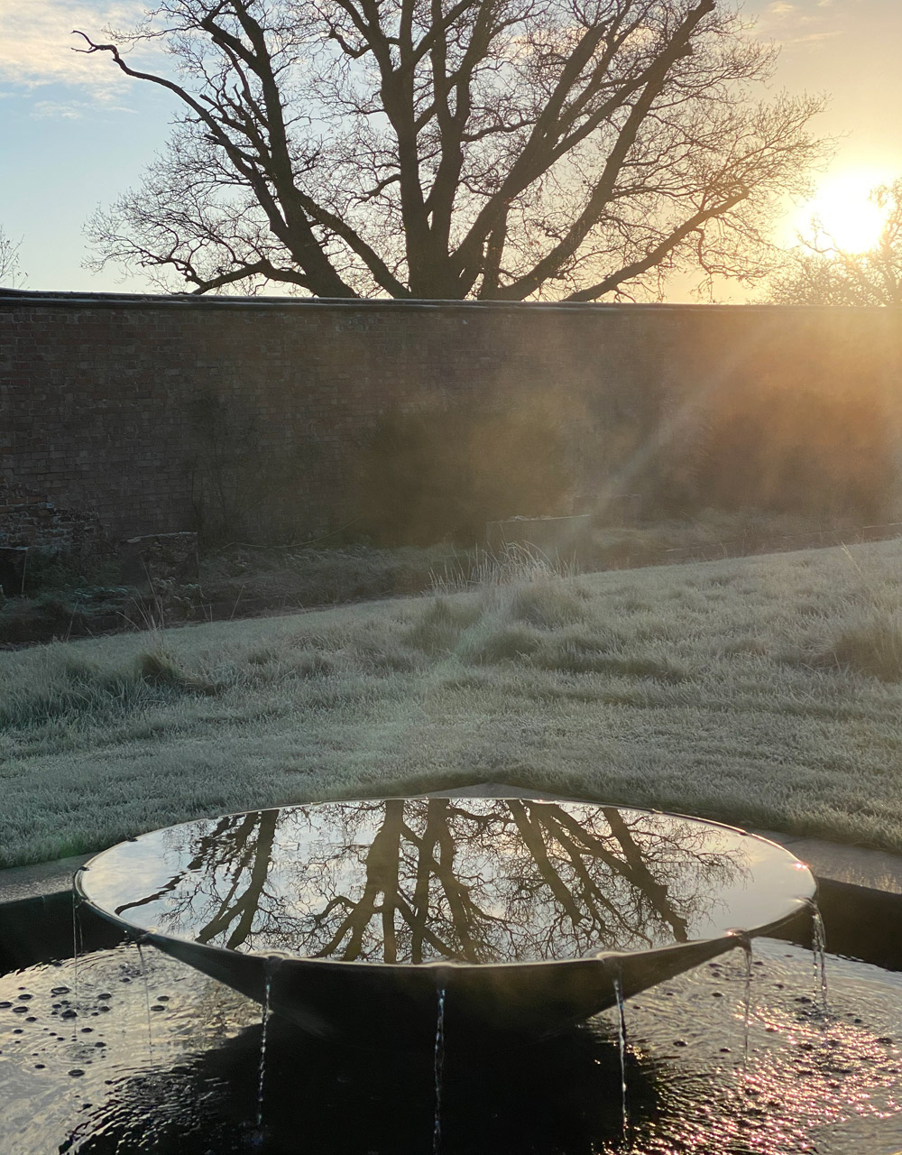 saucer water feature in frosty sunrise